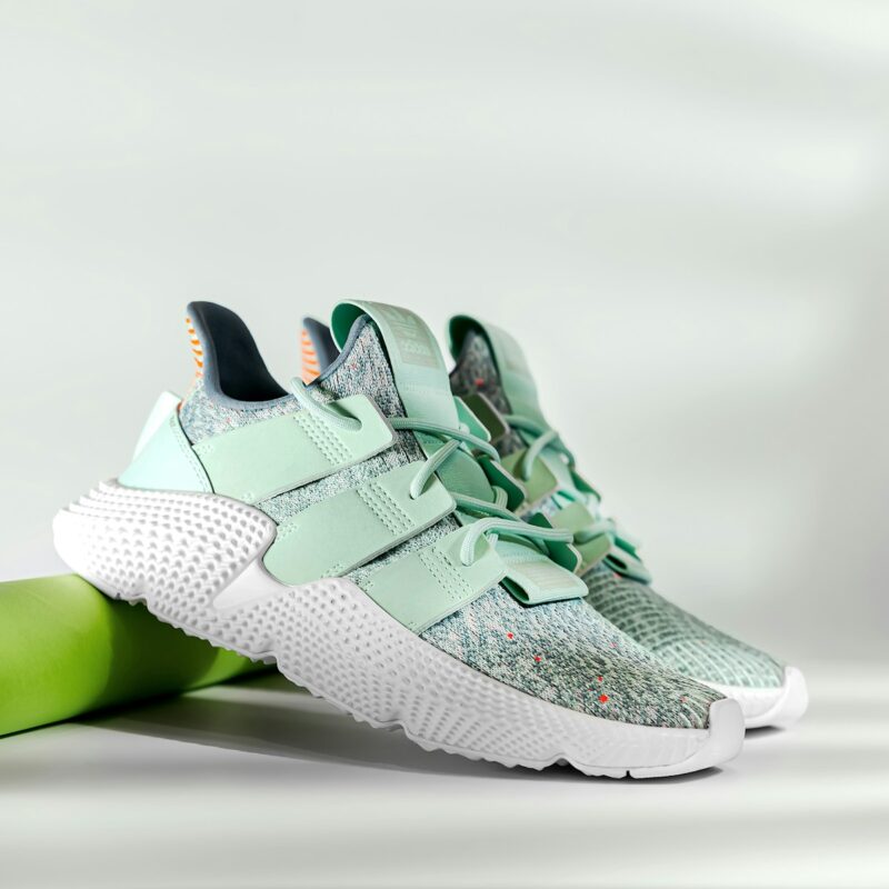 a pair of white and green sneakers