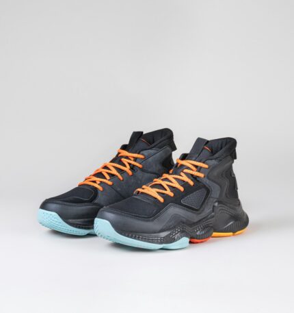 a pair of black and orange sneakers on a white background